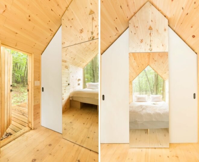 interior of tiny cabin with large glazed wall and wood walls, ceilings and floors