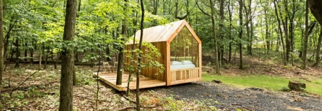 tiny gabled cabin with pitched roof and glazed wall
