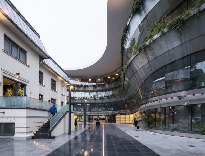 exterior of office building with modern design and greenery planted on the building's balconies