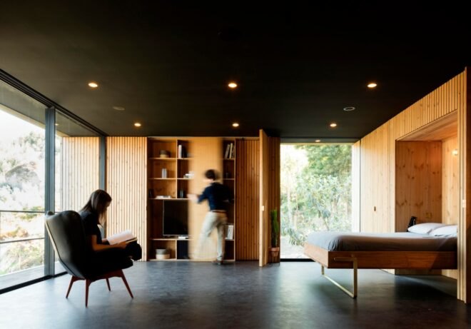 interior living space with black ceiling and timber walls