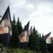 black triangular treehouses with huge glass walls