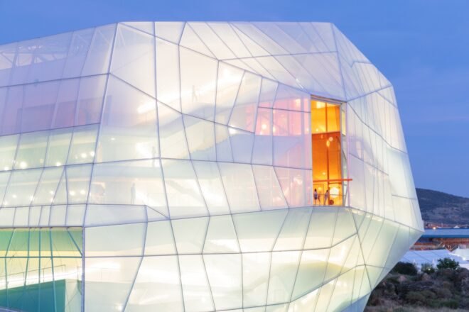 geometric building with clear exterior lit from within