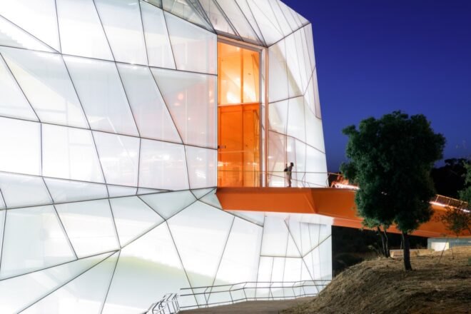 raised walkway leading to translucent geometric building