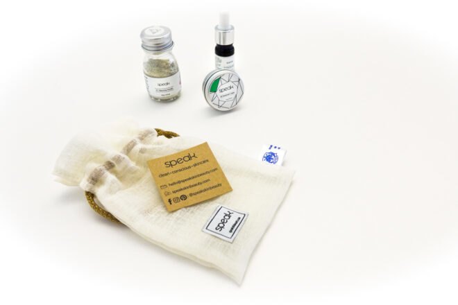 reusable pouch, glass jar, blue amber bottle and metal tin of skincare