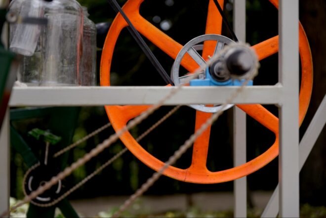 round orange wheel with chain