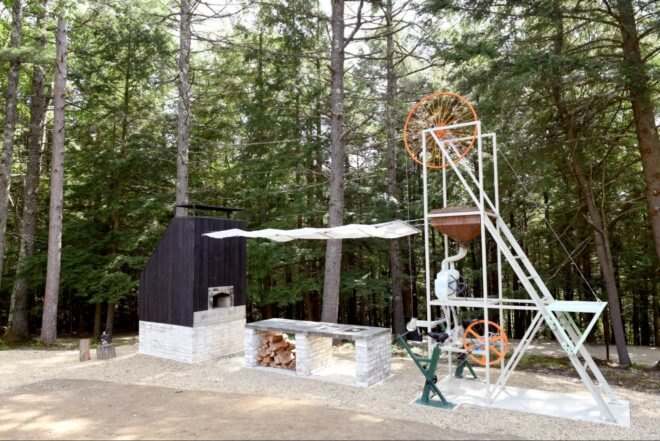 angled view of machine with large wheel and firewood