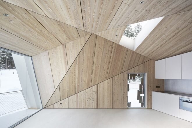 wooden room with geometric walls and skylights