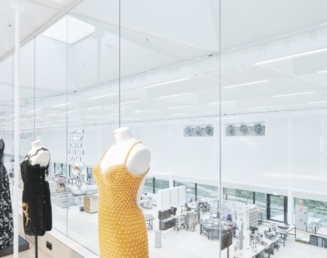 sparkly dresses by a glass wall