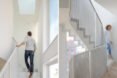 man walking down white staircase