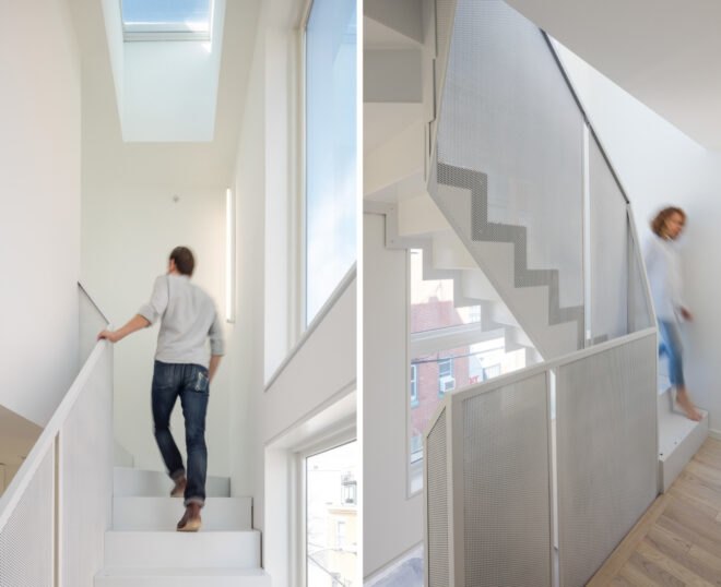 man walking down white staircase
