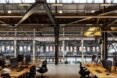 wooden desks with computers in industrial building