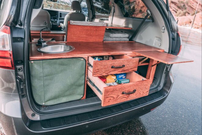 dark camper van with open storage drawers