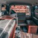 dark camper van with side door open, revealing living space inside