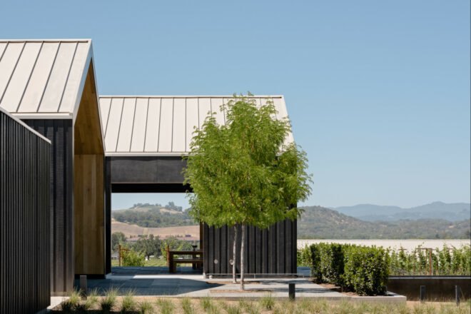 building with gabled roof and mountains in background