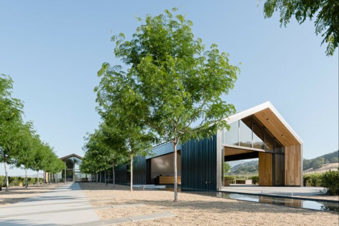 long extended building with gabled roof and black exterior