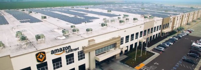 Amazon fulfillment warehouse building topped with solar panels