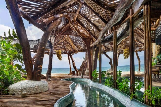 wood deck with thatched overhands and small pool