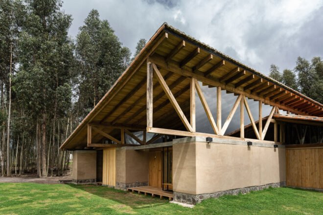 rammed earth home with steep slanted roof