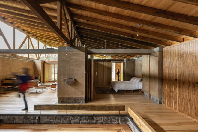 spacious walkway with wood floors leading to master bedroom