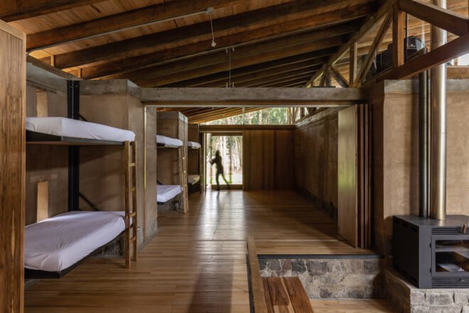 communal area with three bunk beds near a wood-burning stove