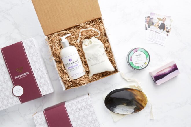 cardboard box with lotions, candle and soap dish