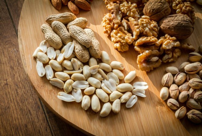 wooden board covered in variety of nuts