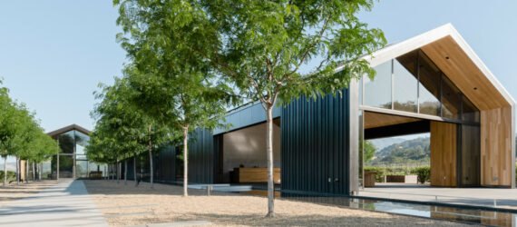 long extended building with gabled roof and black exterior