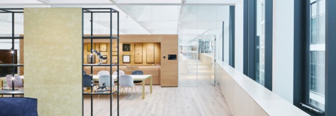 room with wood meeting table and crystals in frames on a wood wall