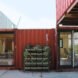 red stacked shipping containers turned into a home