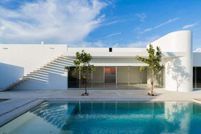 white home behind swimming pool