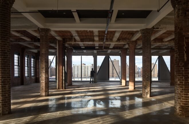 large room with brick walls, brick columns and large windows