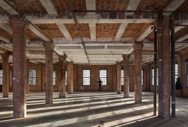 large room with brick walls and brick columns