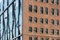 building with brick facade on one side and shiny facade on another side