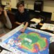 teenagers gathered around board game