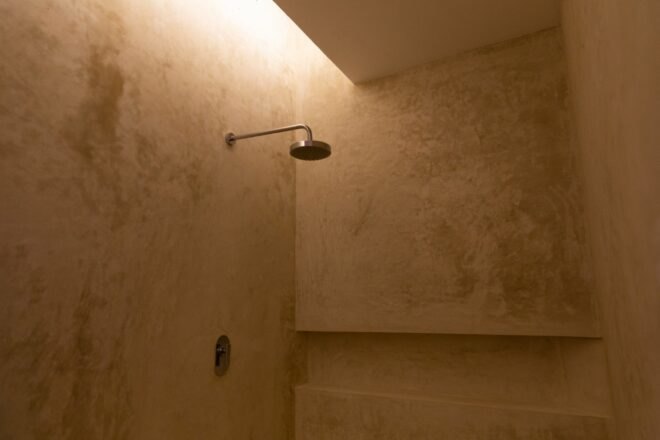 stucco shower stall with showerhead