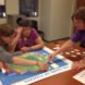 adults gathered around board game