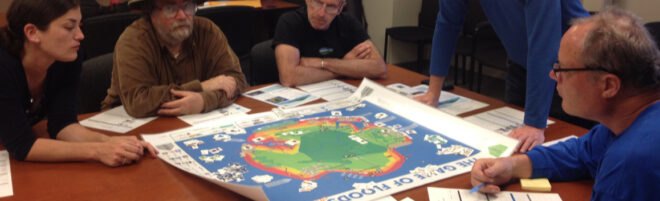 adults gathered around board game