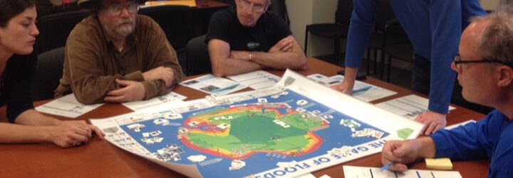 adults gathered around board game