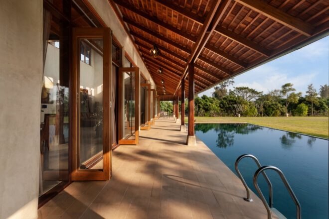 doors of home open to patio and swimming pool