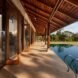 doors of home open to patio and swimming pool