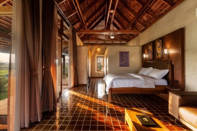 bedroom with stone tile floors and large wood bed