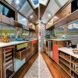Airstream interior with kitchen with white counters and wood cabinets