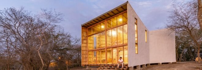 funnel-shaped wooden cabin with all-glass front facade