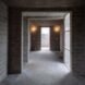 hallway with gray brick walls and large windows
