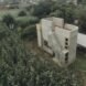 concrete and rammed earth home surrounded by plants