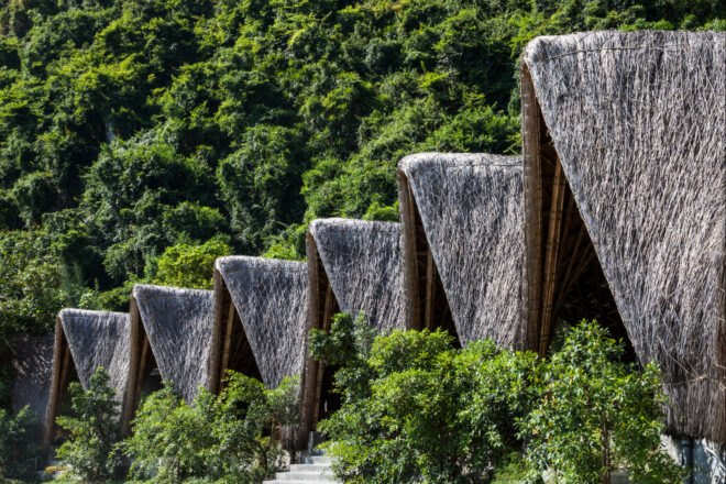 series of thatched roof huts on a remote beach