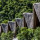 series of thatched roof huts on a remote beach