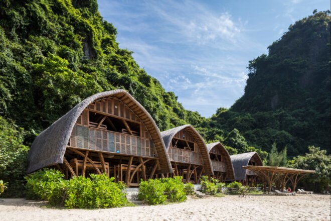 series of thatched roof huts on a remote beach