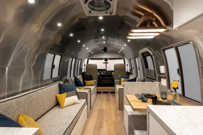 Airstream interior with three light gray sofas