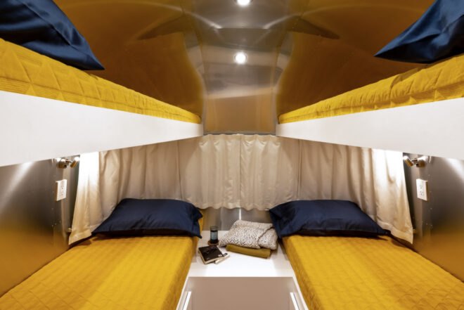 two bunk beds with mustard-colored decor